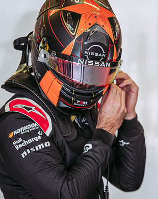Formula E Racer adjusting Racing Helmet